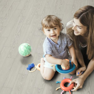 Mother and toddler playing with toys on floor