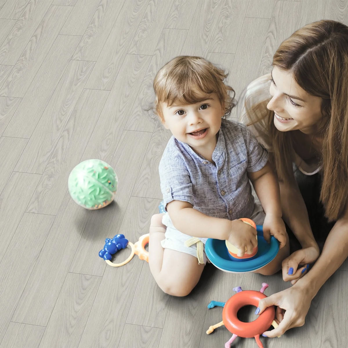 Mother and toddler playing with toys on floor