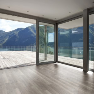 Modern home interior overlooking mountain lake