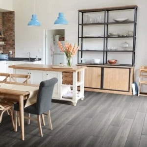 Modern kitchen with wooden furniture and blue pendant lights