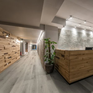 Modern office corridor with wooden accents and plants