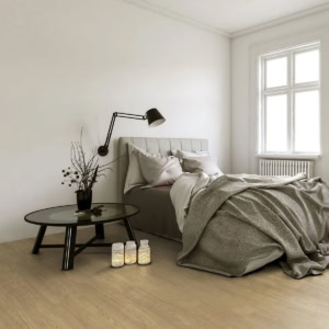 Minimalist bedroom with grey bed and stylish black lamp