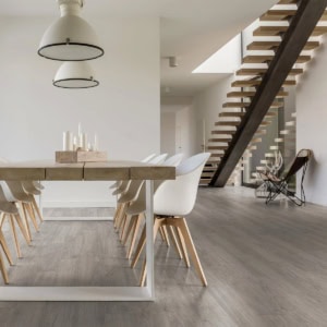 Modern dining room with floating staircase and unique chairs